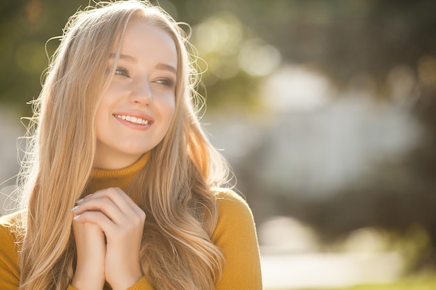 Closeup portrait of young beautiful woman. Female outdoors.