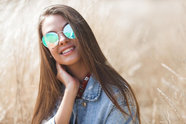 Closeup portrait of young beautiful woman outdoors. Attractive female on neutral background.