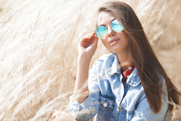 Closeup portrait of young beautiful woman outdoors. Attractive young female