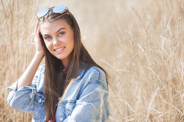 Closeup portrait of young beautiful woman outdoors. Attractive young female