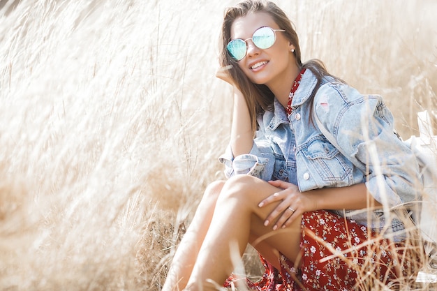 Closeup portrait of young beautiful woman outdoors. Attractive young female