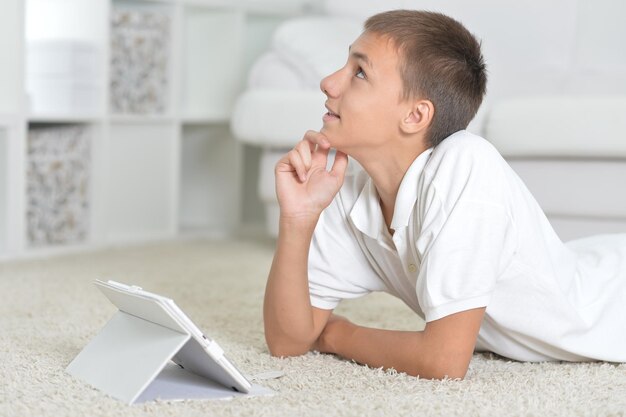 Closeup portrait of a young boy with the tablet