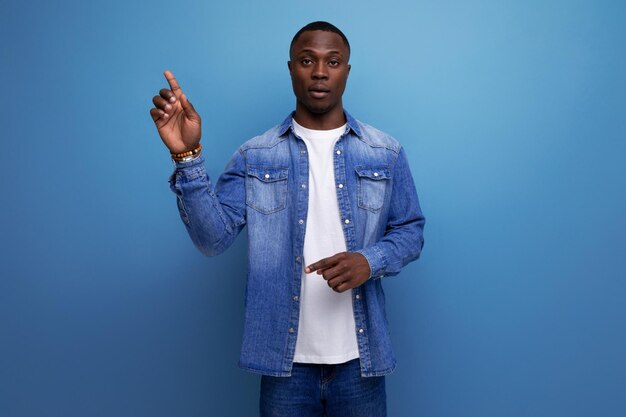 Closeup portrait of a young handsome smart african guy in a denim jacket inspired by an idea on a