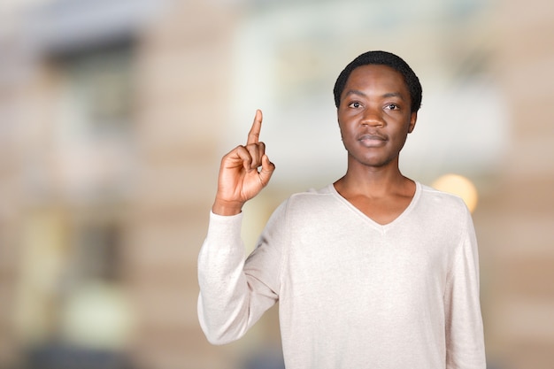 Closeup portrait of young man pointing up