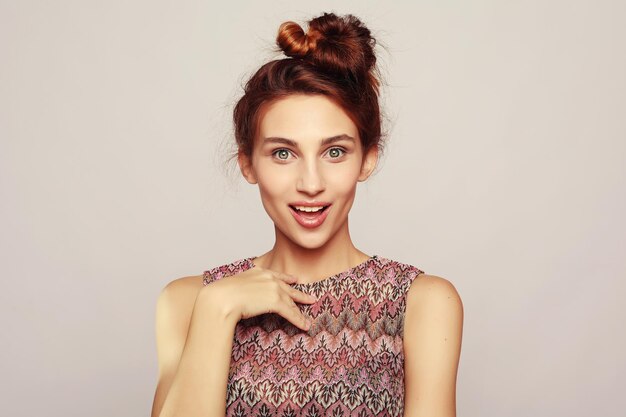 Closeup portrait of young pretty surprised woman with opened mouth standing with open palms