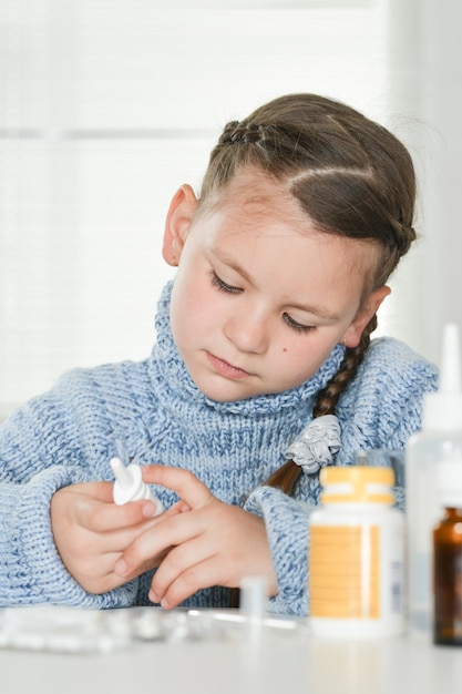 Closeup portrait of young sick girl with medicines