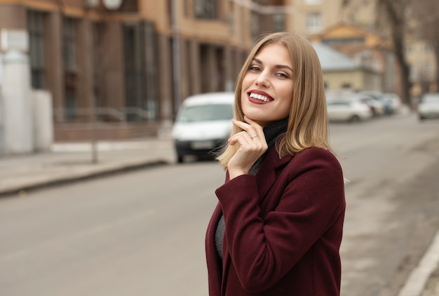 Closeup portrait of young woman outdoors with copy space. Beautiful blond girl model.