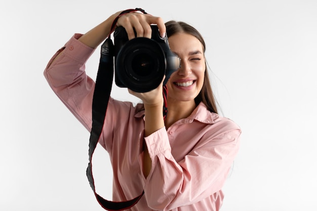 Closeup portrait of young woman photographer taking photo lady working in photostudio using