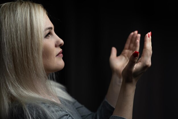 Closeup portrait of a young woman praying.