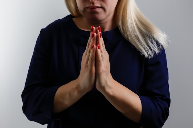 Closeup portrait of a young woman praying