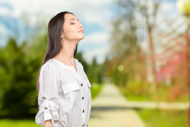 Closeup portrait of a young woman praying