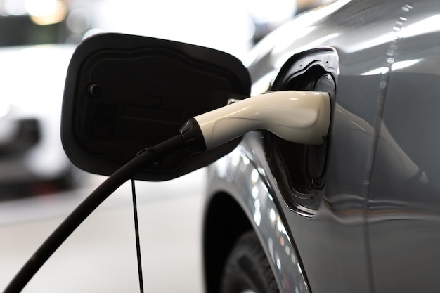 Closeup of power supply plugged into an modern electric car Electric or EV car charging station