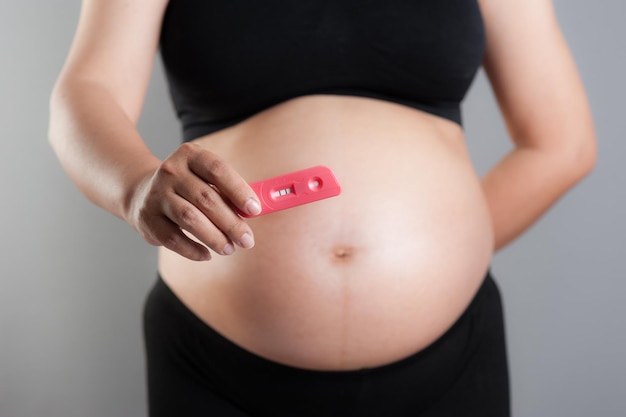 Closeup pregnancy test in pregnant woman's hand