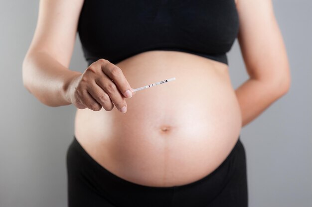 Closeup pregnancy test in pregnant woman's hand