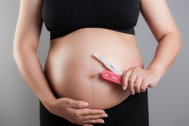 Closeup pregnancy test in pregnant woman's hand