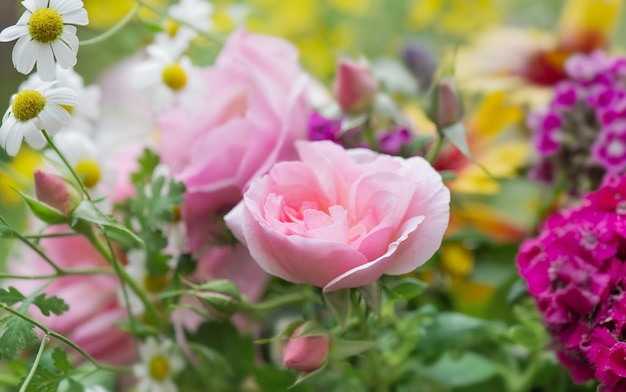 Photo closeup on pretty rose in a bouquet of flowers freshly picked in the garden