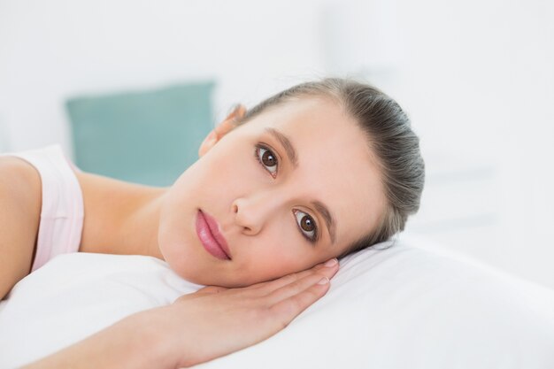 Closeup of a pretty woman relaxing in bed