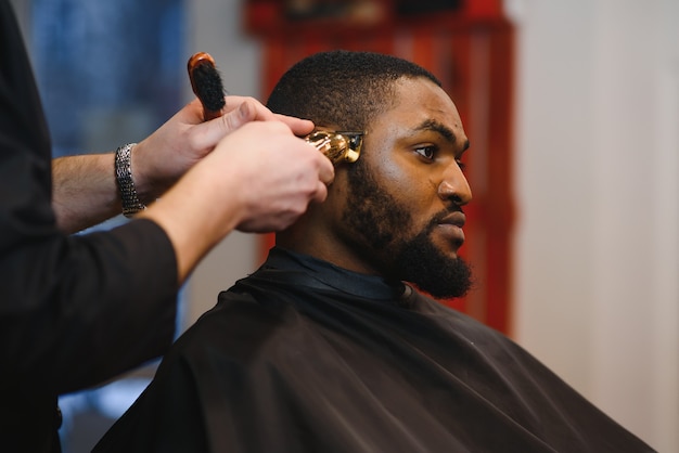 Closeup of process of trimming of hair in barber shop