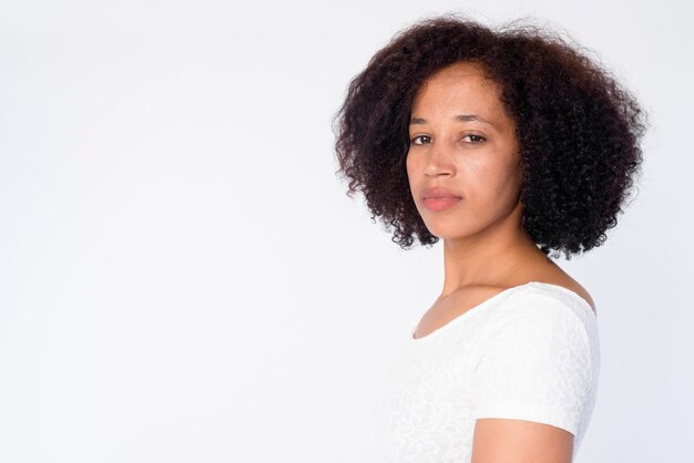 Closeup profile view of young beautiful African woman looking at camera