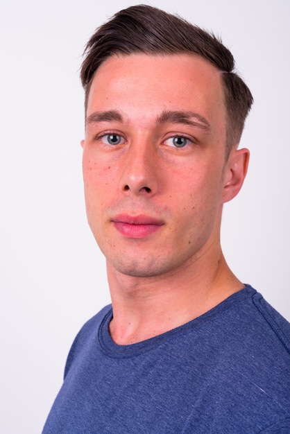 Closeup profile view of young handsome man looking at camera