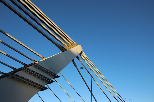 Closeup of the pylon of the cablestayed bridge and cables on both sides of the pylon and the stre