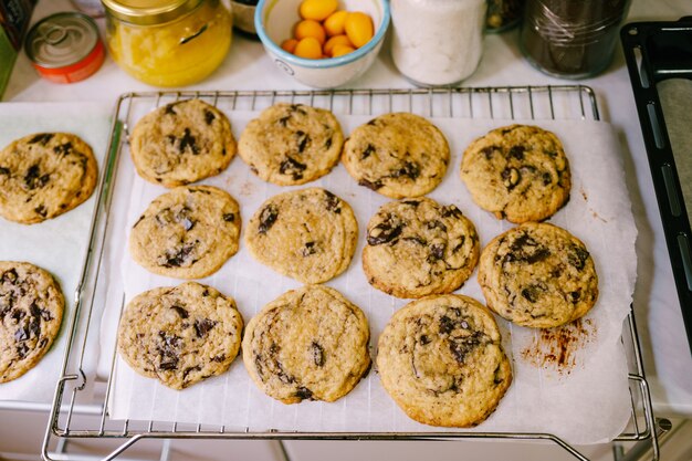 Closeup of readymade american cookies with chocolate crumbs on the baking lot with paper