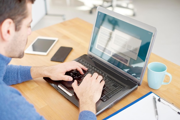 Closeup and rear view shot of businessman typing on computer