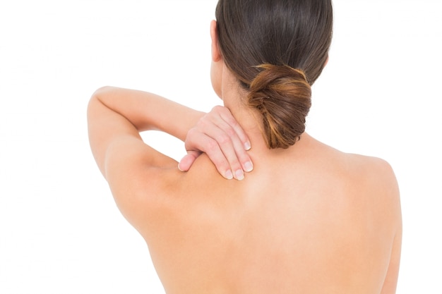 Closeup rear view of a topless woman with shoulder pain