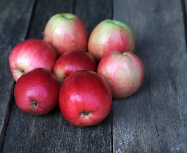 Closeup of red apples on the background of an old board