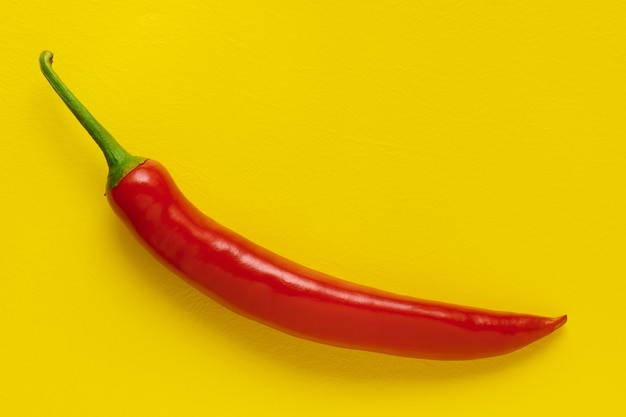 Closeup red chili pepper on yellow