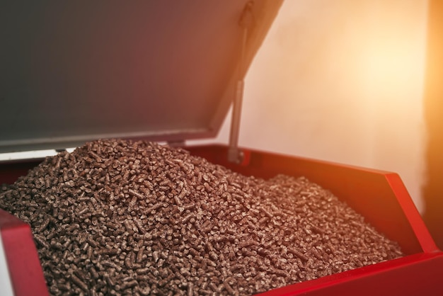 Closeup of a red color pellet oven in the household Wooden pellet boiler room