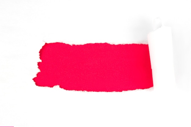 Closeup of a red hole on white paper, copy space.