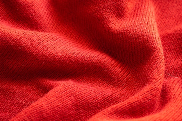 Closeup red knitted woolen fabric texture background