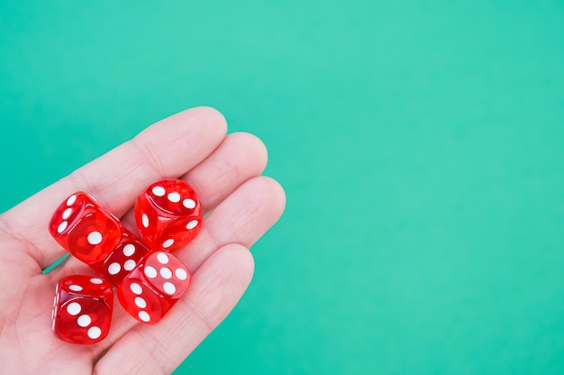 Closeup of red rolling dice on a blue background