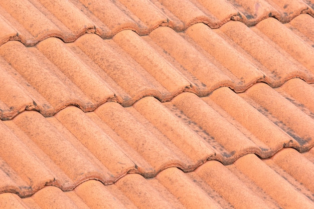 Closeup of the red roof tiles with stains