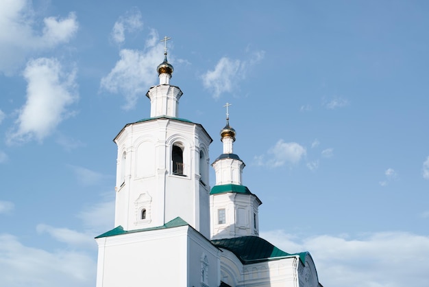 Closeup religious architecture of Middle Ages Ancient white church old monastery facade against blue sky outdoors