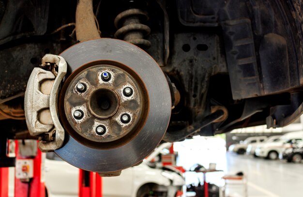 Closeup repair disc brakes of car with soft-focus in the background. over light