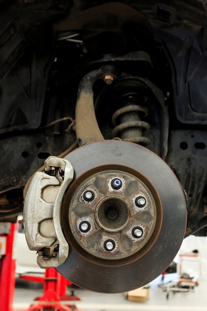 Closeup repair disc brakes of car with soft-focus in the background. over light