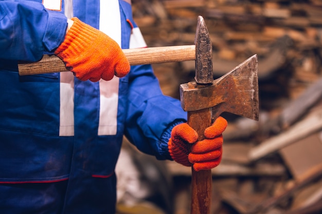 Closeup of repairman in uniform, professional builder working using construction equipment. Process of building, apartment renovation, repairing, building. Sawing, connecting, cutting, preparing.