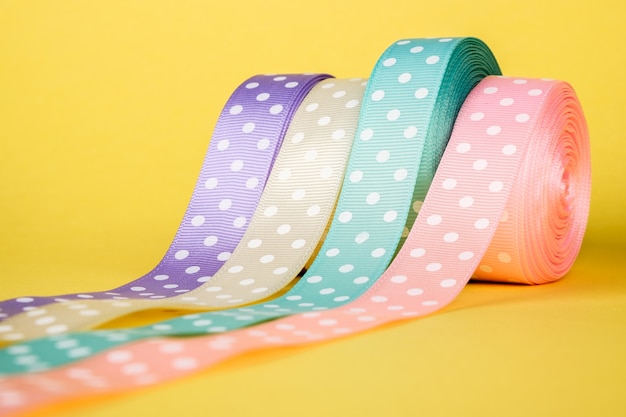 Closeup of ribbon roll over colorful 