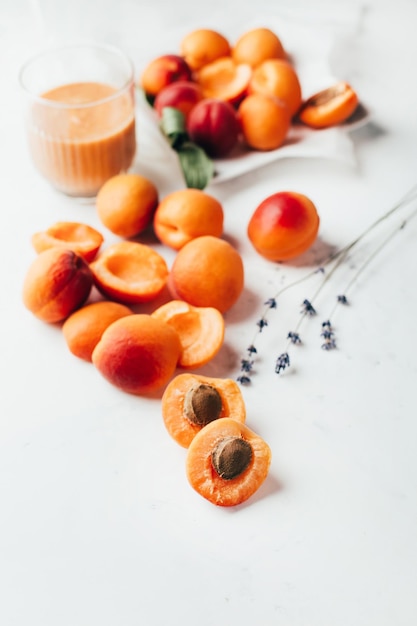 Closeup on ripe apricots and apricot smoothie on white background