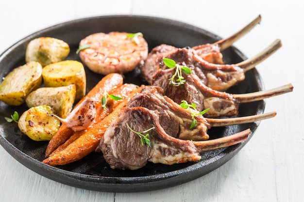 Closeup of roasted lamb ribs on the white table