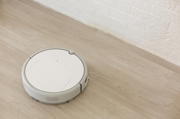 closeup robotic vacuum cleaner over white background