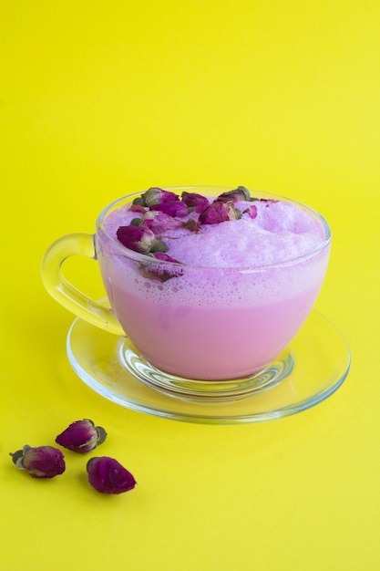 Closeup on rose moon milk in glass cup on the yellow