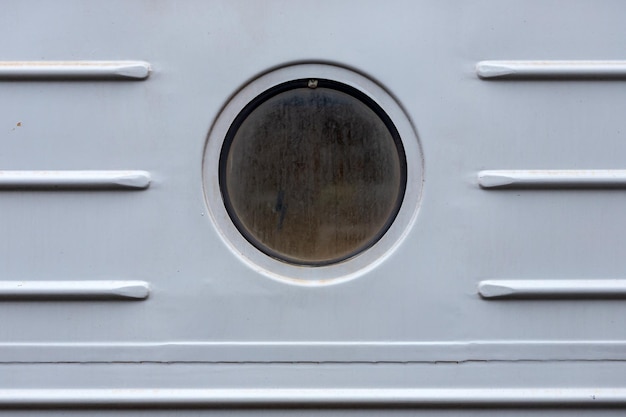 Closeup of a round window in old stoun house