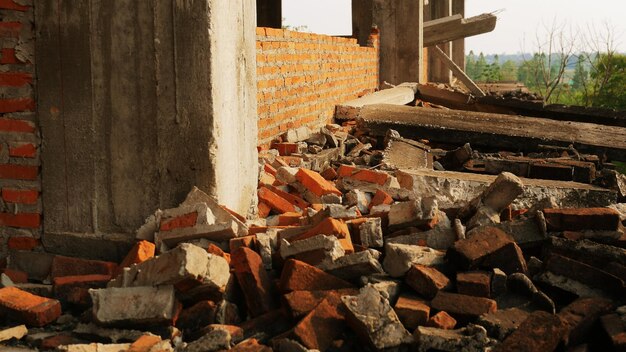 Closeup of the rubble of an industrial building collapsing into a pile of concrete and brick and the jagged debris caused by the failure of the engineers at the abandoned construction