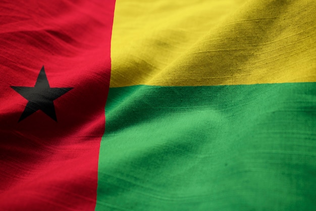 Photo closeup of ruffled guinea-bissau flag, guinea-bissau flag blowing in wind