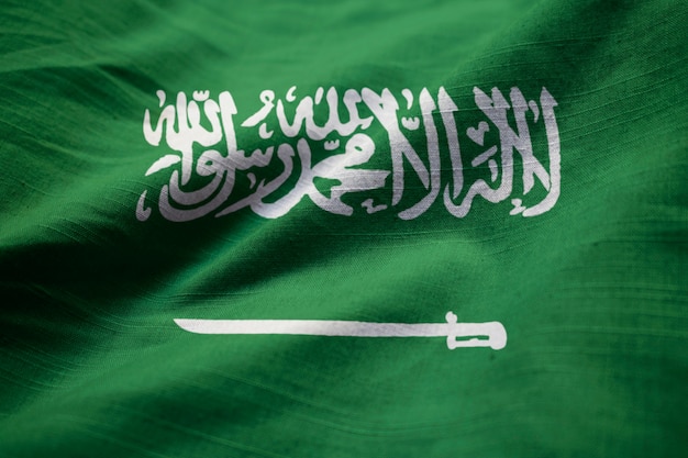 Photo closeup of ruffled saudi arabia flag, saudi arabia flag blowing in wind