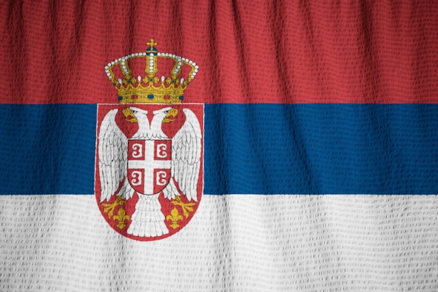 Photo closeup of ruffled serbia flag, serbia flag blowing in wind