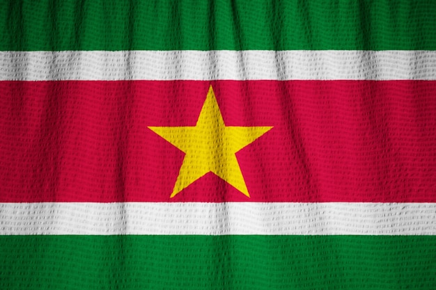 Photo closeup of ruffled suriname flag, suriname flag blowing in wind